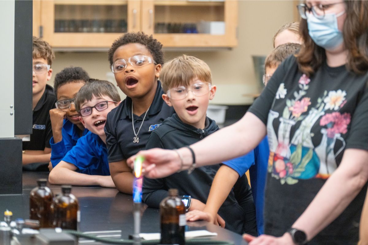 Dr. Danielle Garret and elementary students at an outreach event