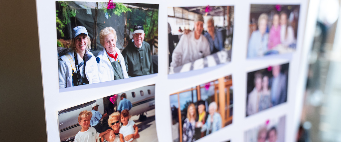 A display board with several family photographs of Barbara Massey Rogerspinned in rows