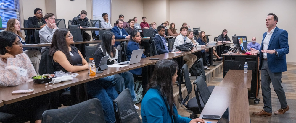 Business classroom students listening to presenter