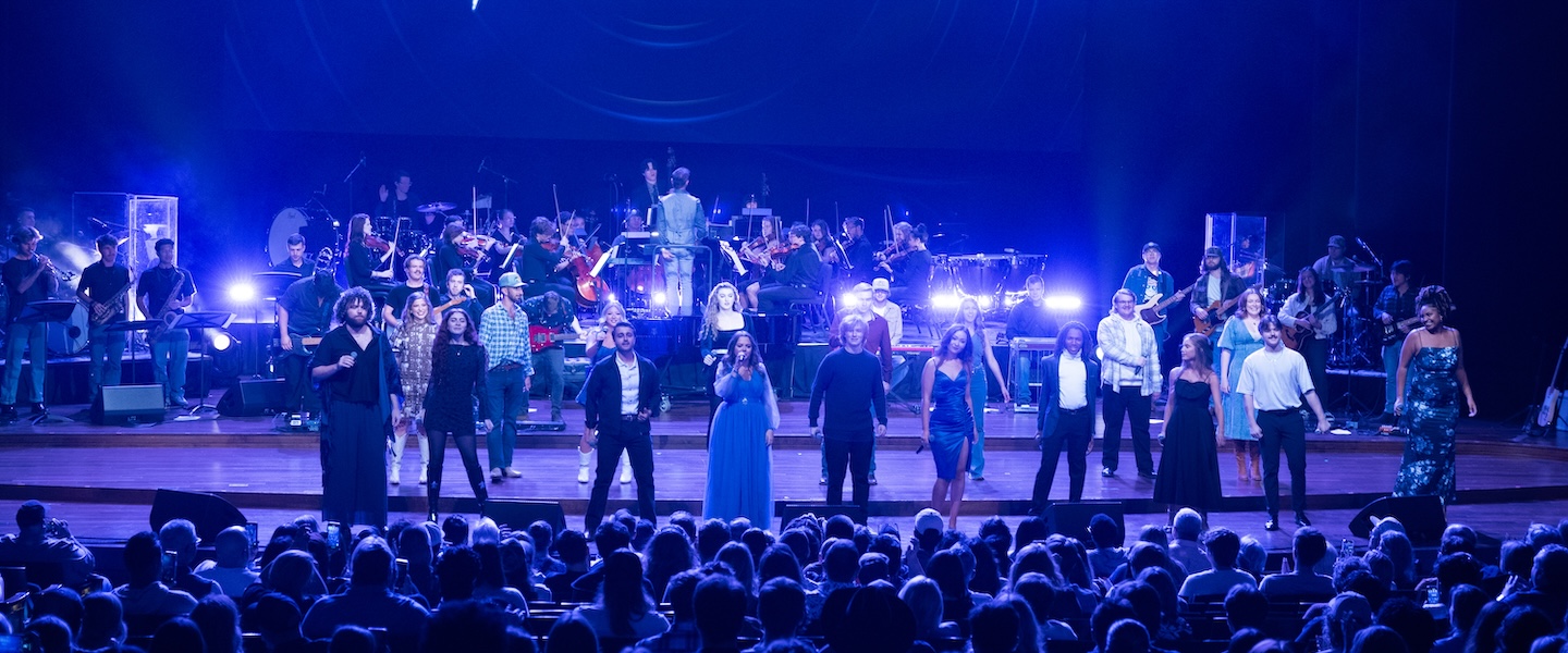 Singers perform on stage