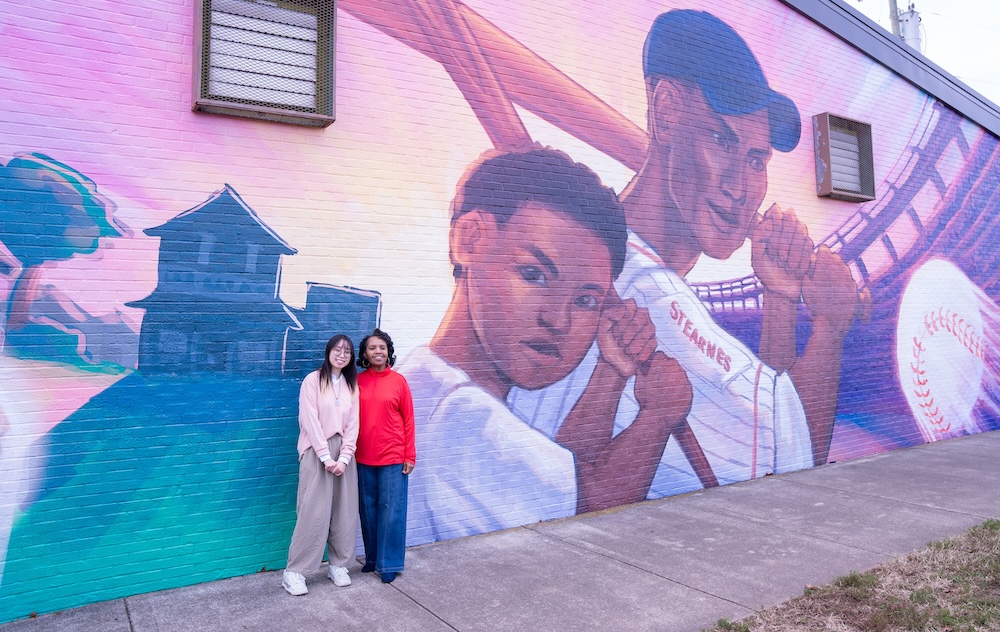 Wu and Dr. Kimbro Hamilton with mural