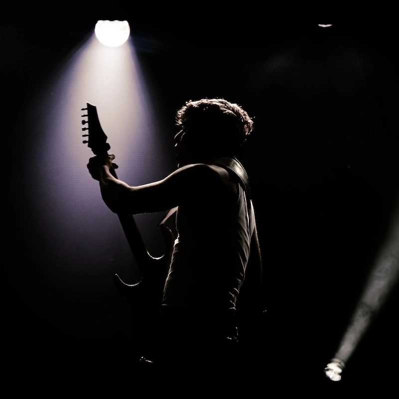 silhouette of musician playing guitar 