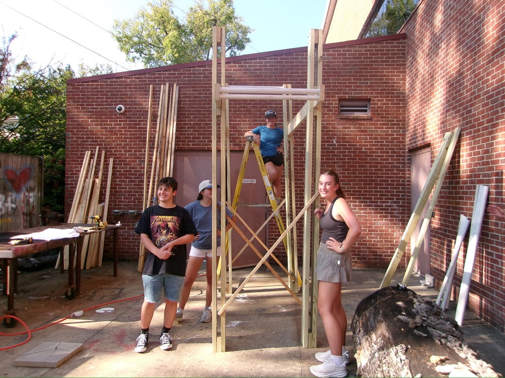 students smile from construction day