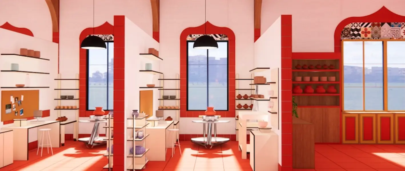 Moore's design: A well-lit pottery studio with warm red and cream tones, featuring arched windows with decorative tile details. The space is divided into individual workstations with shelves displaying ceramic pieces, pottery wheels, and worktables. Pendant lights hang from the ceiling, and a large wooden shelf holds rows of red clay pots. The windows reveal a scenic outdoor view of a body of water and distant buildings