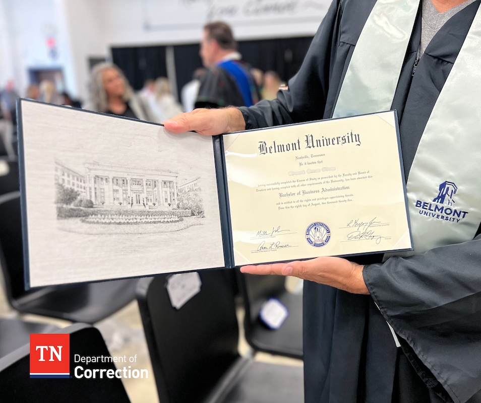 Belmont graduate holds a Bachelor of Business Administration diploma during the Turney Center commencement ceremony.