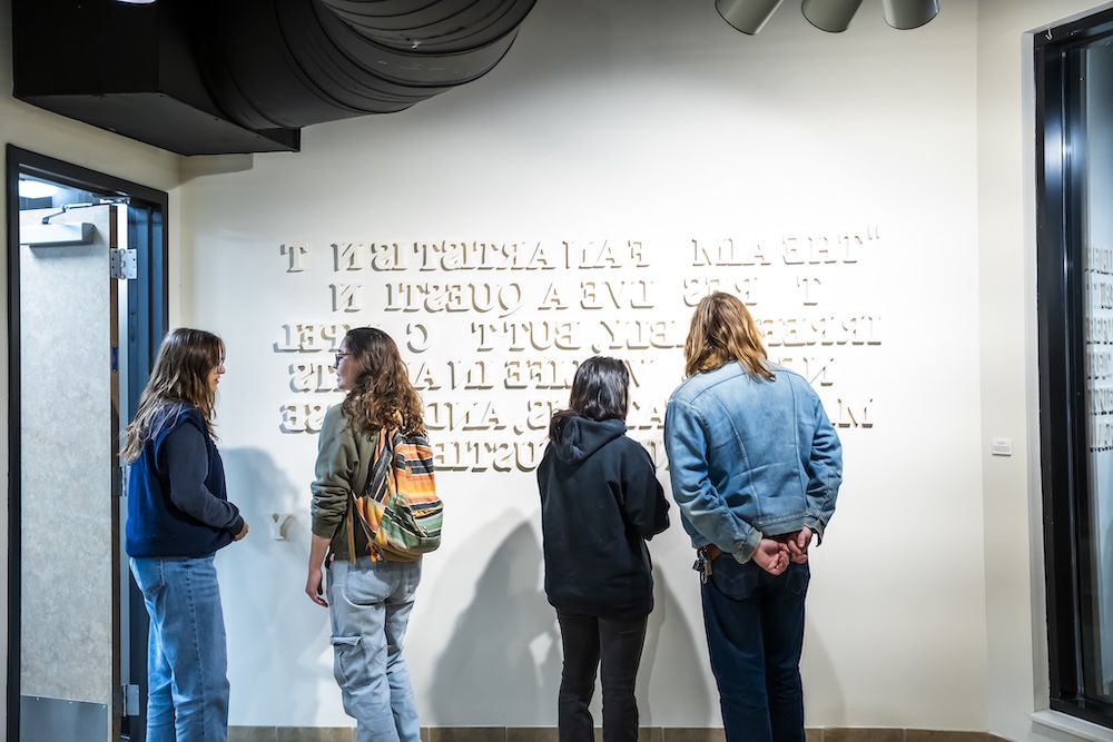 students looking at the Tolstoy quote brought through