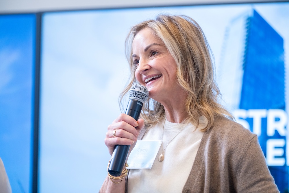 a panel speaker talks into the microphone
