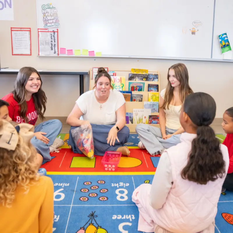 belmont education students in classroom with little kids