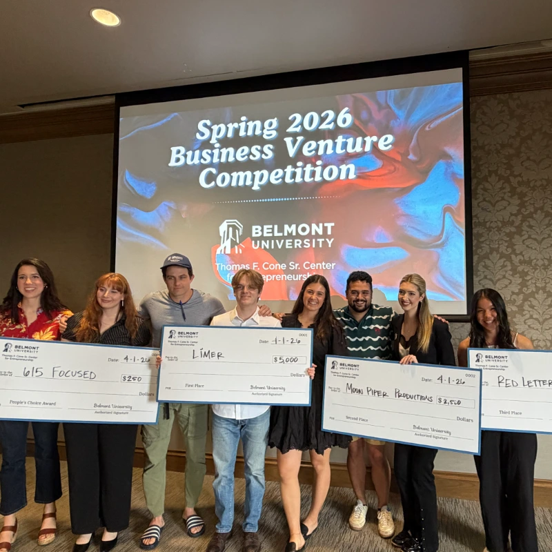 Winners pose with a check