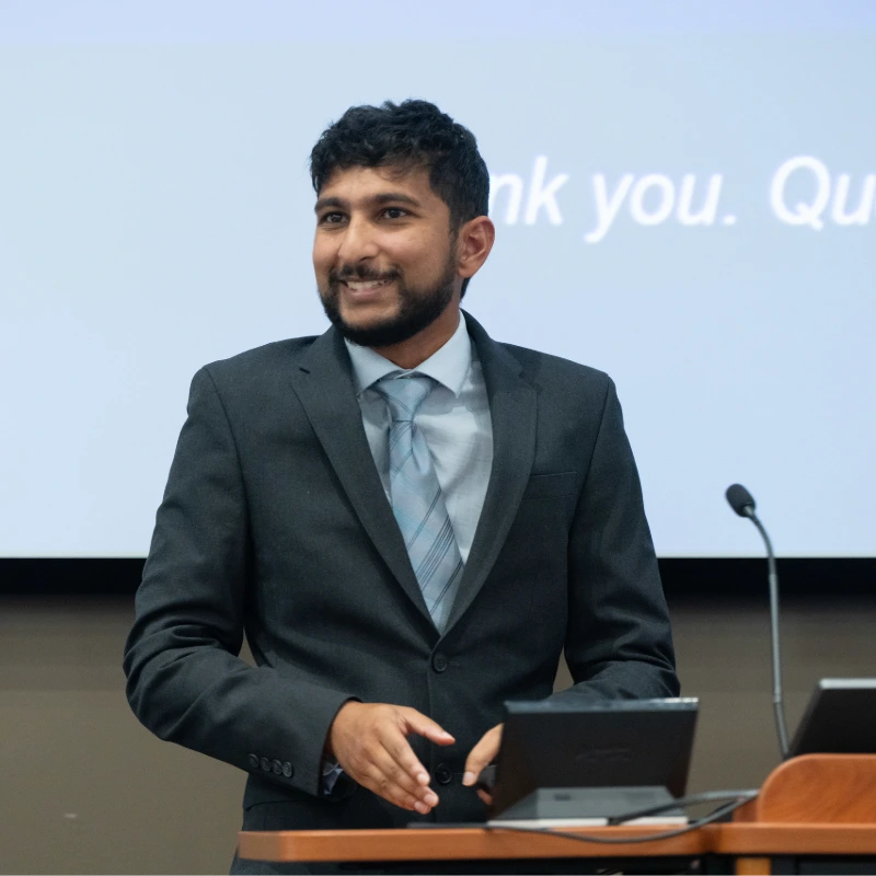 Dr. Ben Ryan speaks to a room of medical students, faculty and mentors about global research.
