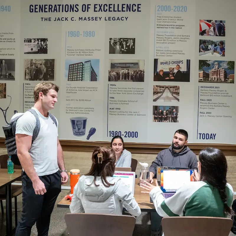 students meeting in the business building lobby