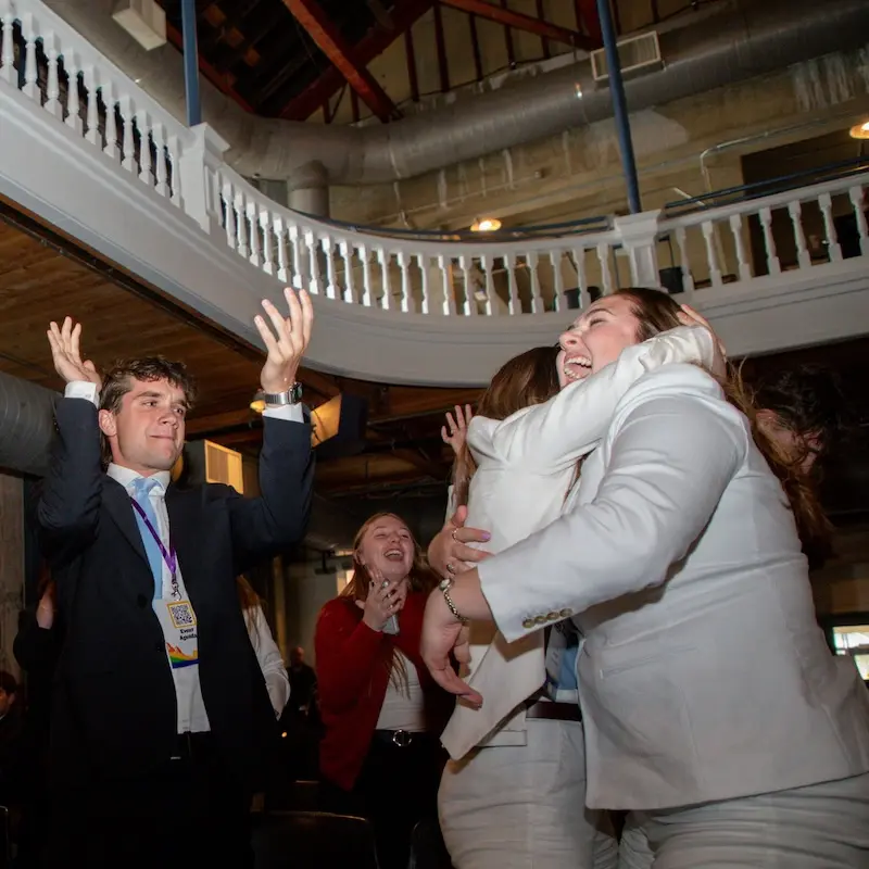 Enactus member hug and celebrate