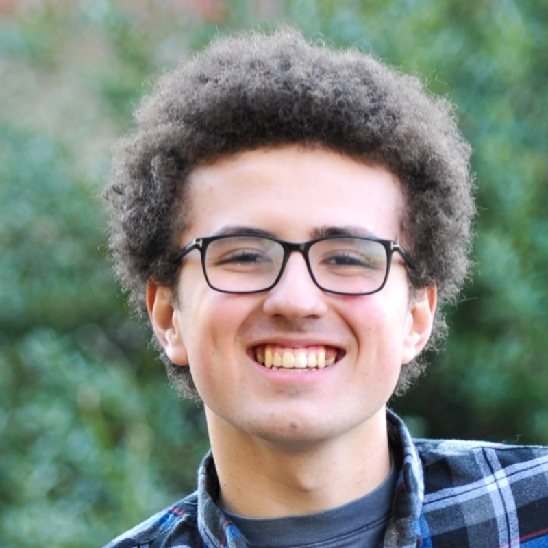 A headshot of James Shepard smiling