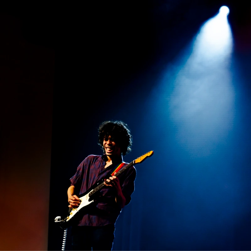 Commercial Guitar student playing on stage