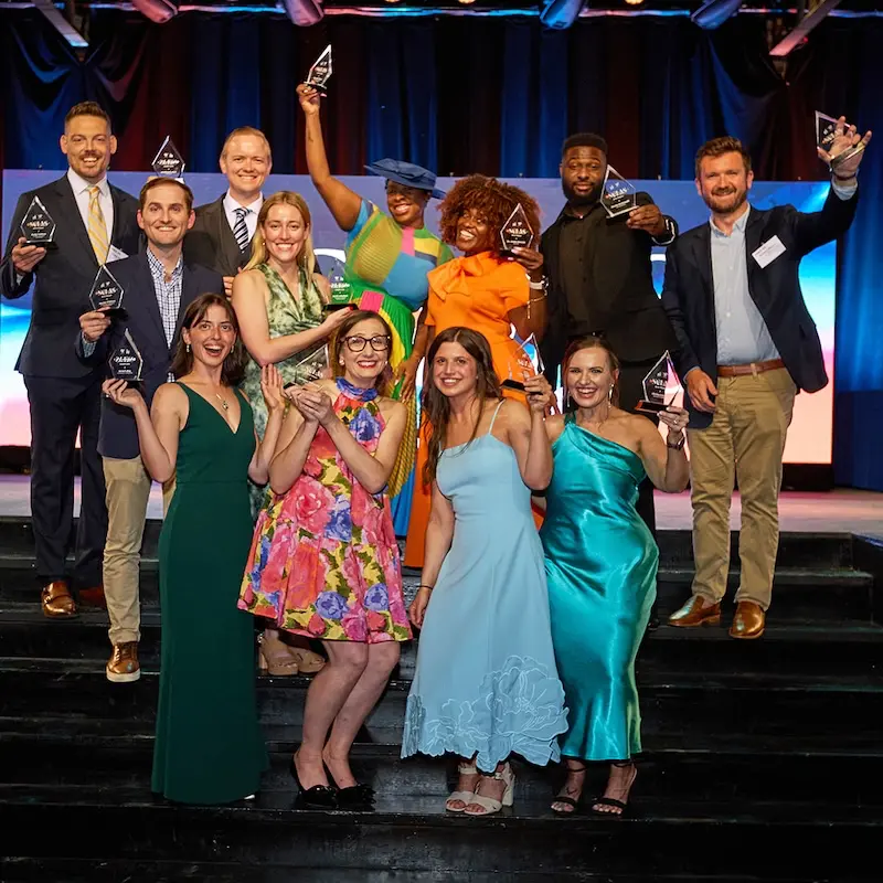 Winners holding awards in the air 