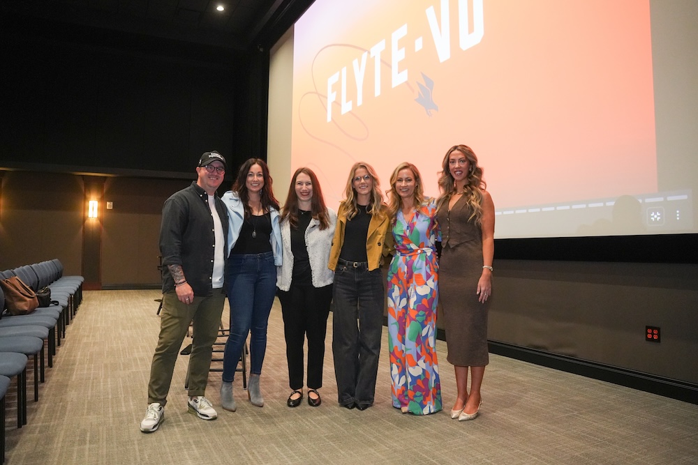 Group of people in front of Flytevu logo. 
