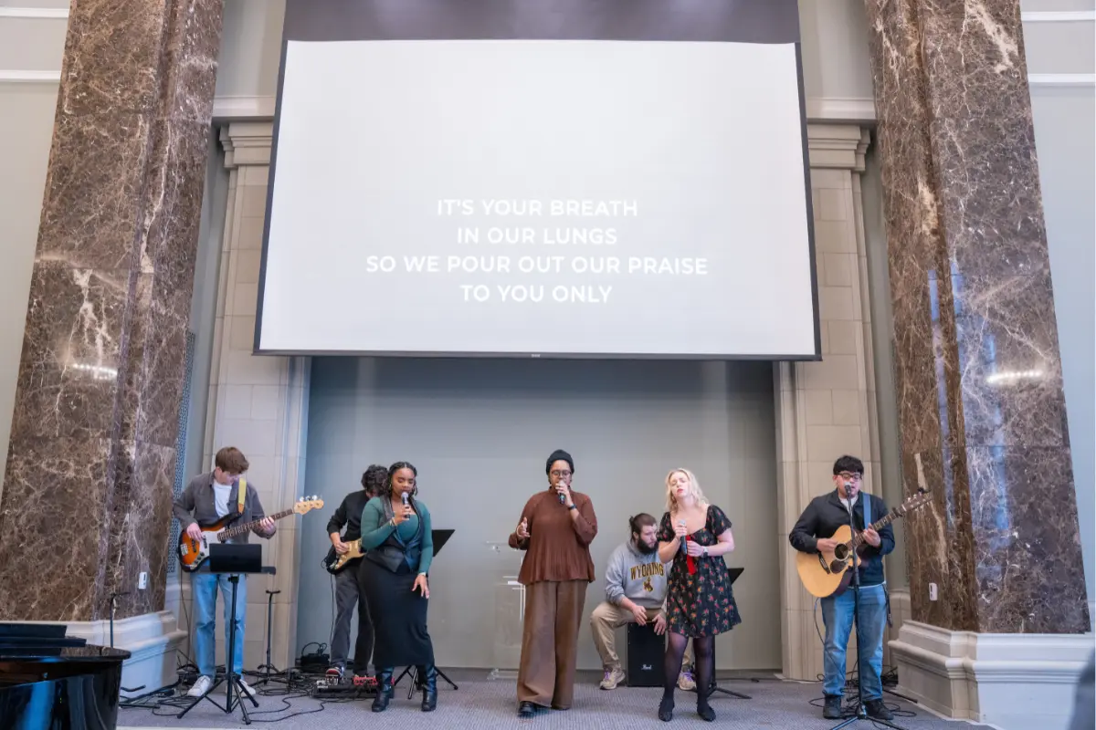 Belmont students stand together performing on stage 