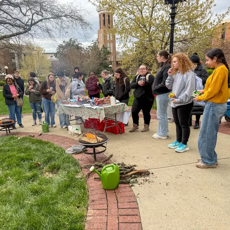 Students outside attending event and having snacks