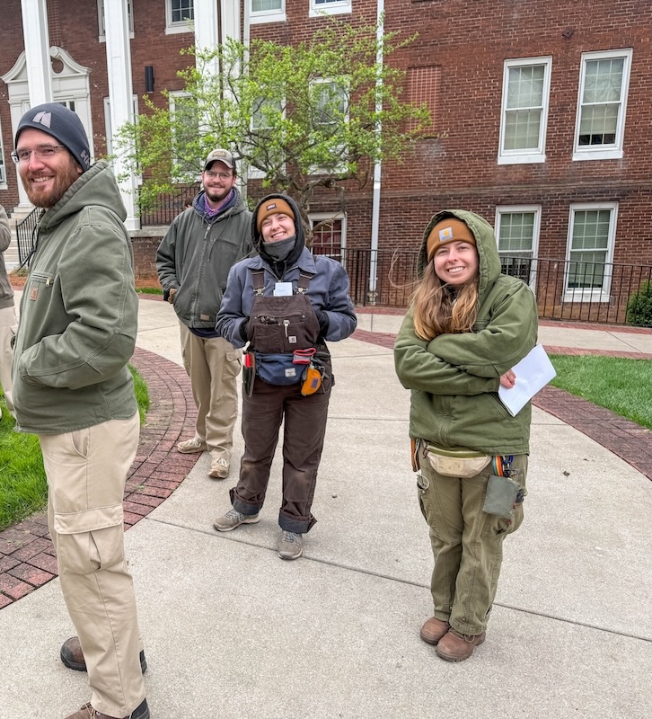 Four people standing outside in cold weather attire