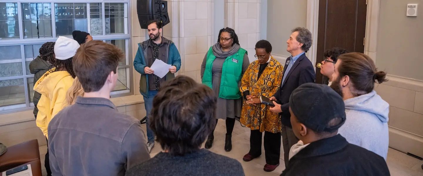 students and faculty standing in a circle
