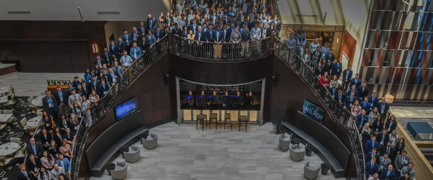 TVA Investment Club members on large staircase