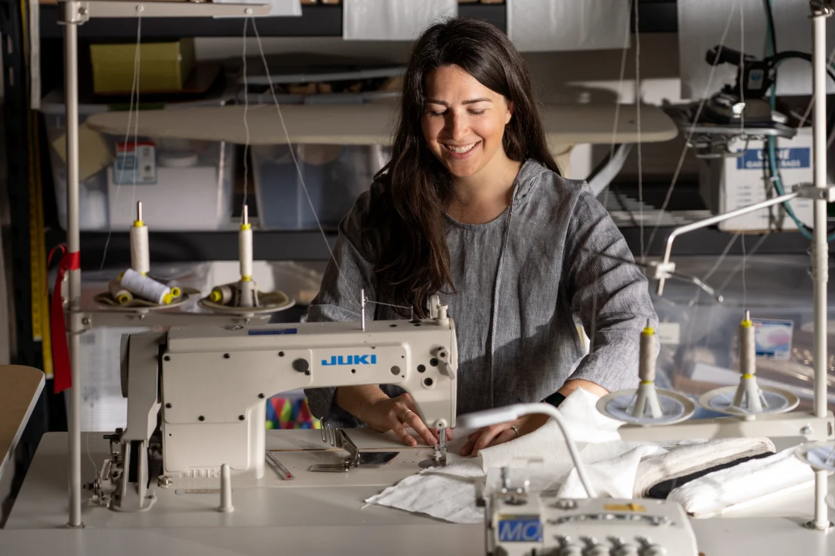 Andie Day at a sewing machine