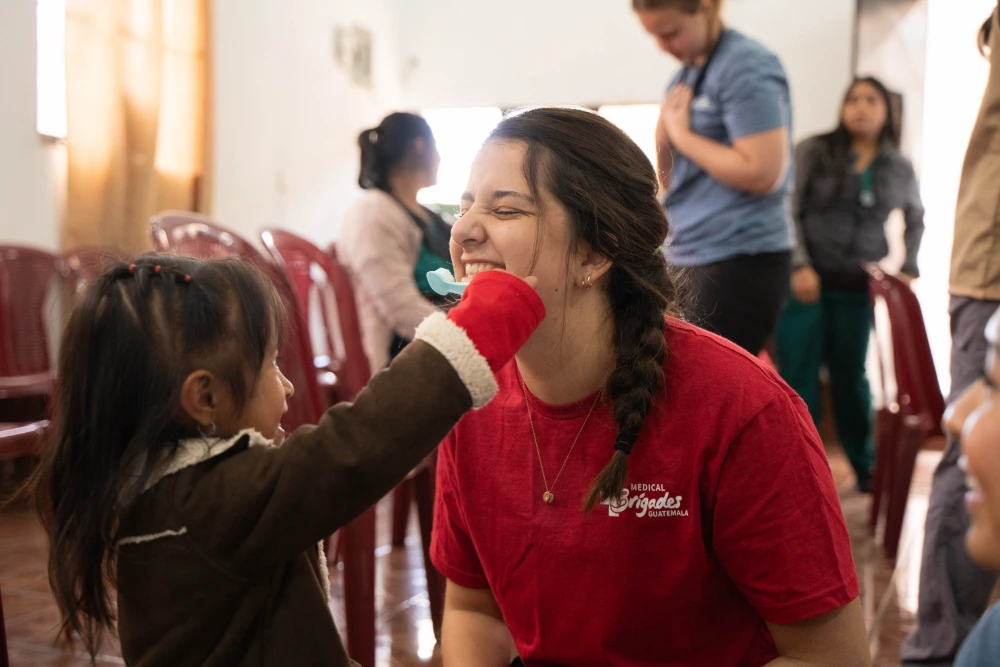 A student volunteer working with kids in the clinic