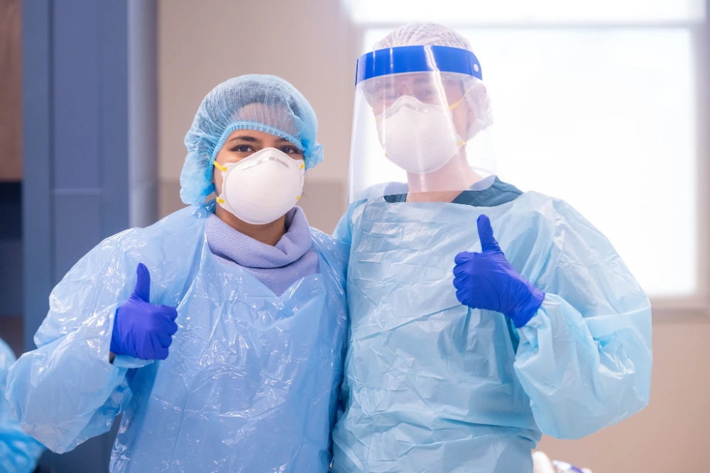 Simulation participants pose in PPE