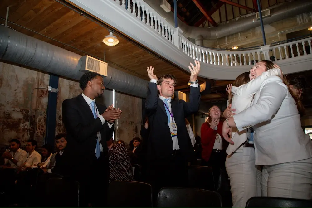 Enactus members celebrating and hugging