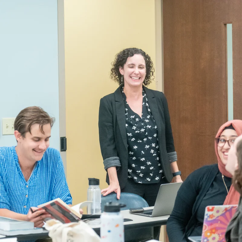 Susan Finch teaching a class of smiling students