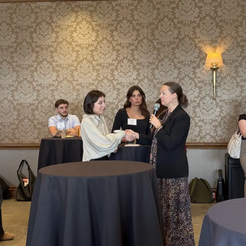 Jill Robinson shaking hands with student