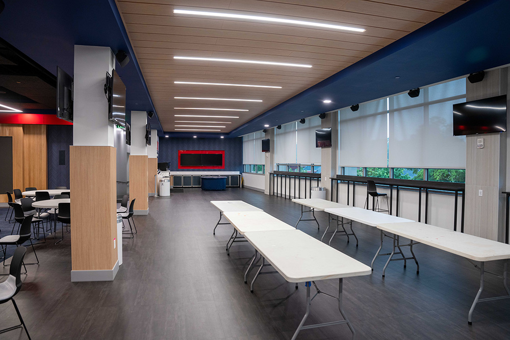 Vince Gill Room empty, but showing screens, long tables, and other features that are apart of the room.