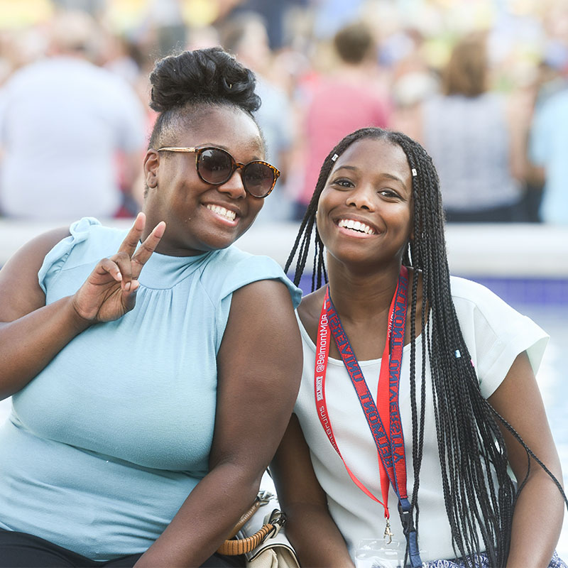 A student and her mom posing with a peace sign