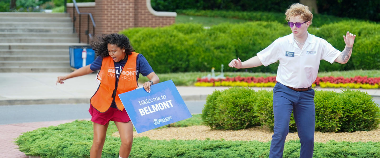 Two Orientation leaders dancing on Belmont's Acklen/15th Ave Roundabout