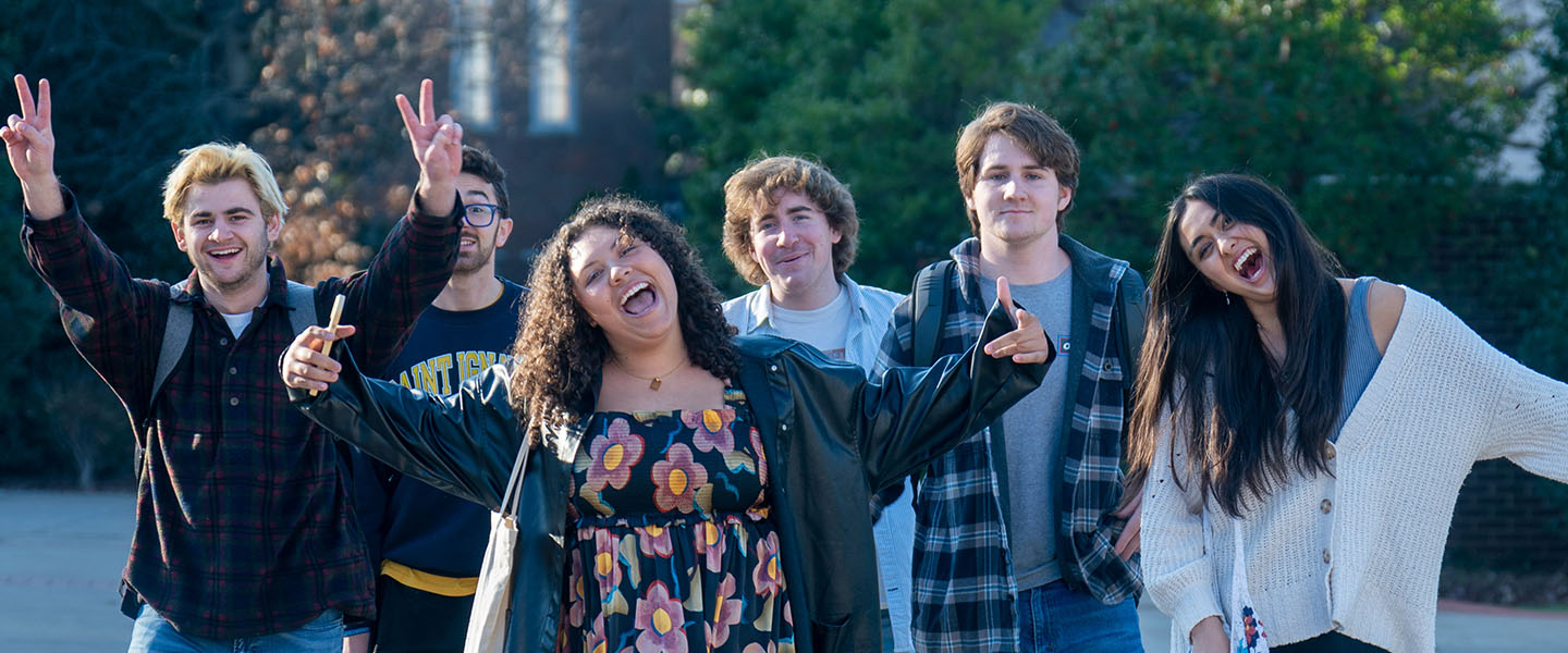 A group of students walking down a sidewalk on campus