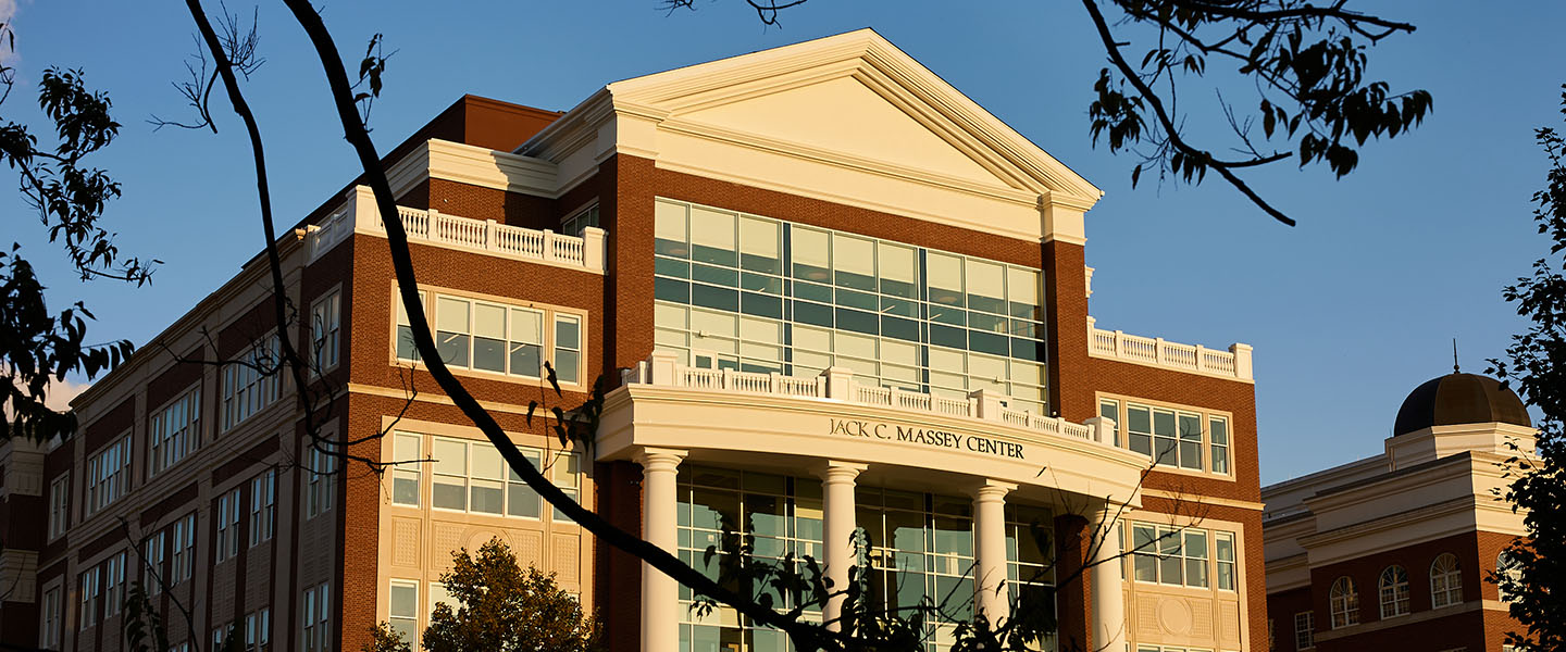 Exterior view of the Jack C. Massey Center on Belmont University's campus, bathed in warm sunlight with trees framing the scene.