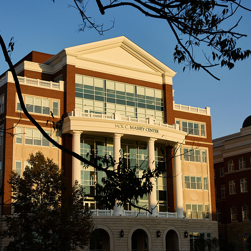 Exterior view of the Jack C. Massey Center on Belmont University's campus, bathed in warm sunlight with trees framing the scene.