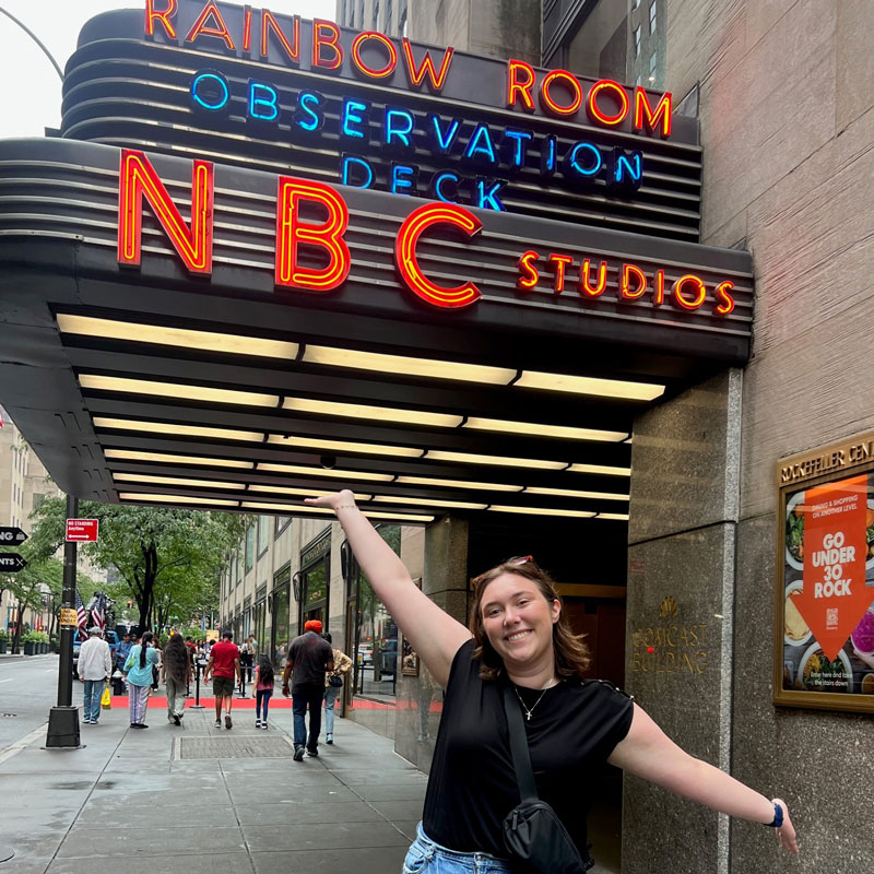 woman standing in front of New York City's Rainbow Room