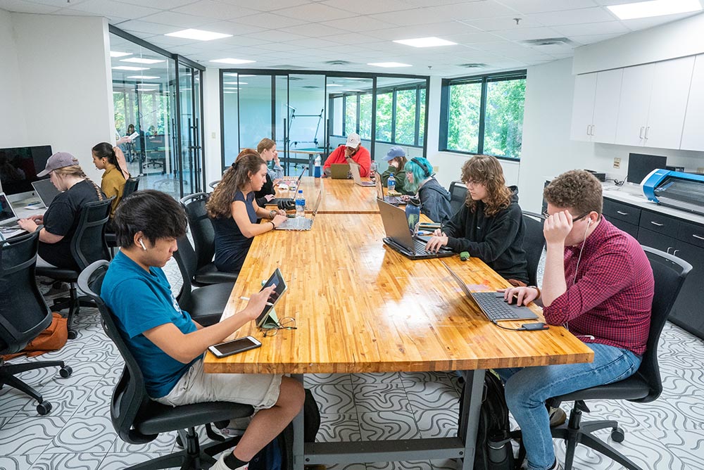 students and faculty seated around table