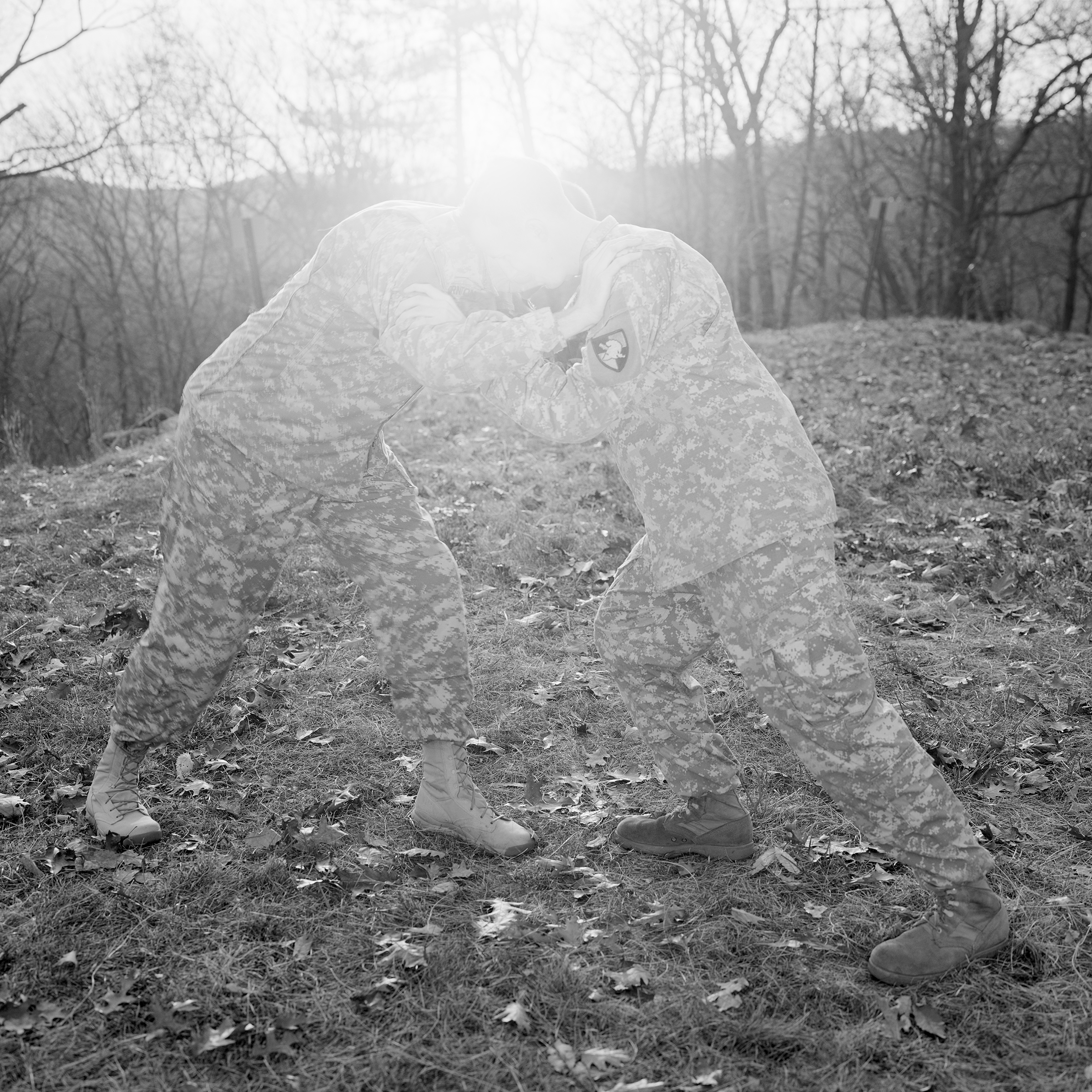two transparent figures resist one another in a natural landscape