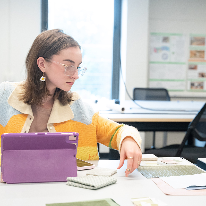 Student looking through material samples