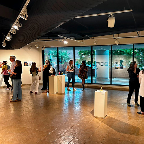 people in gallery looking at art