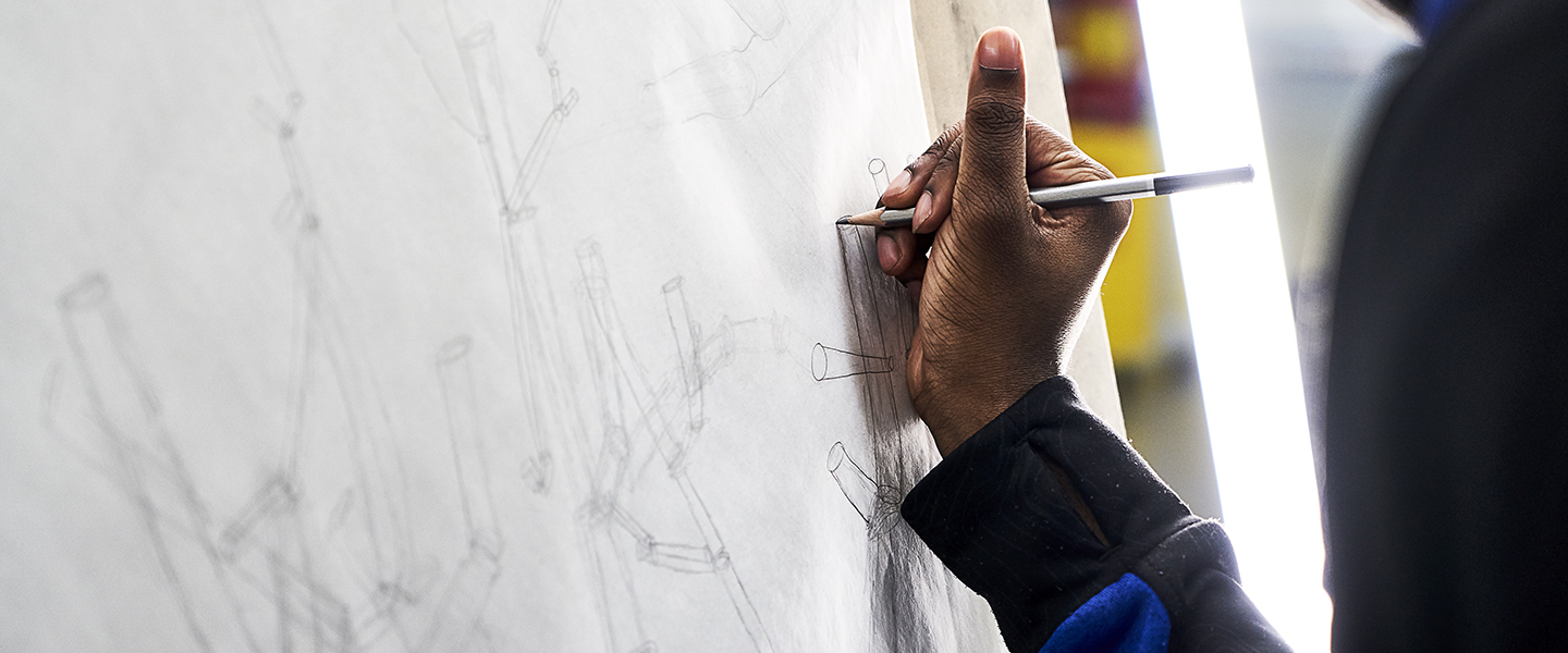 Close up of Student working on pencil drawing