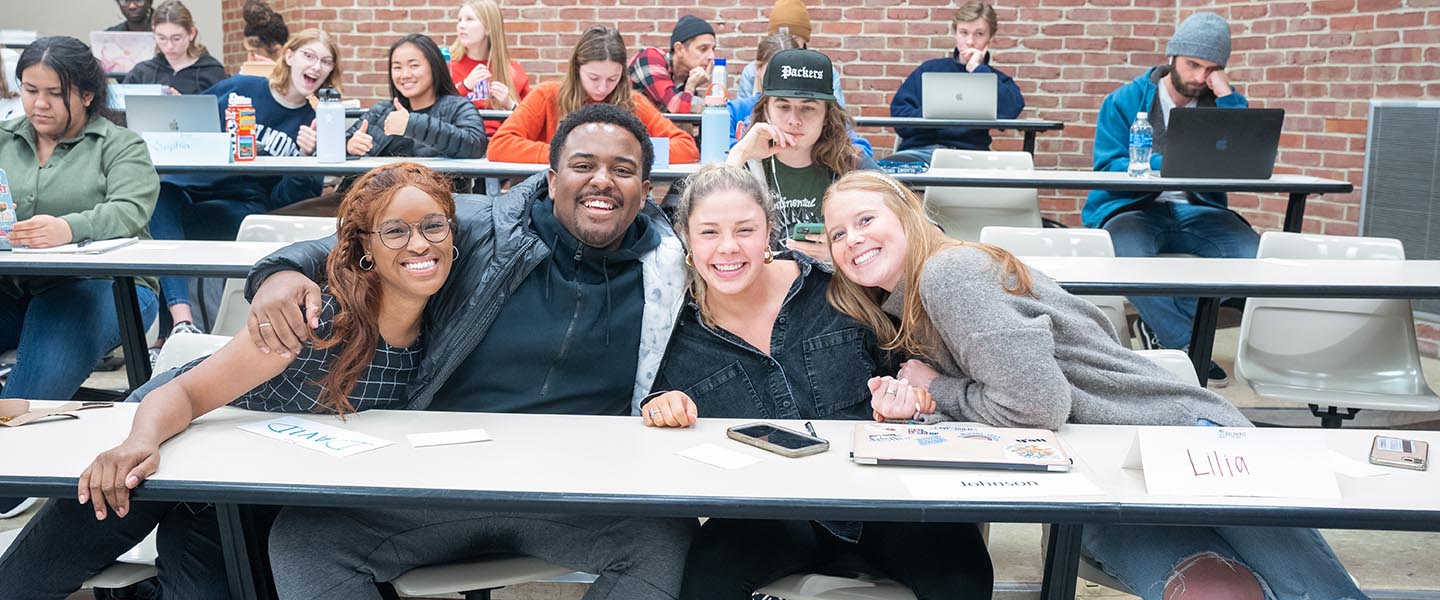 Student pose for picture in classroom during the Rayvon Owen whys your why class